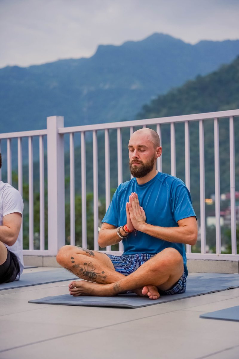 Group Yoga classes Bajamar La Laguna Tenerife with green trees in the background. 